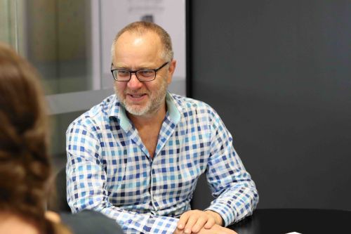 Patrick Fensham sitting at a desk